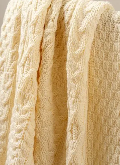 Close-up of cream Aran throw draped across chair